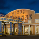 Disney’s Hotel Cheyenne in Disneyland Paris met westerngevels en verlichte entree bij avond